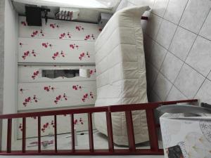 a bedroom with a bed and a pillow with red flowers at Chambres d'hôtes - Les Orchidées in Perpignan