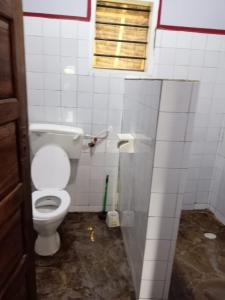 a bathroom with a white toilet in a stall at Daijan villa in Ukunda