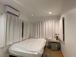 Postel nebo postele na pokoji v ubytování T-home Maerim