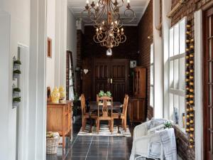 a dining room with a table and a chandelier at Bluewater Guesthouse in Port Elizabeth