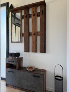 a mirror hanging on a wall above a table at Studio cosy au Crêt du Chardon in Chambost-Allières +9 photos