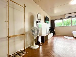 a living room with a fan and a bedroom at Lykke Room Poppular Condo P1 in Ban Bang Phang
