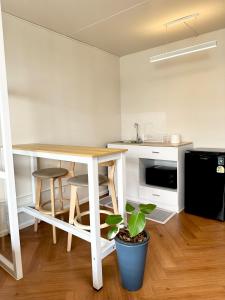 a small kitchen with a table and a table at Lykke Room Poppular Condo P1 in Ban Bang Phang +11 photos
