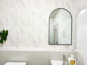 a bathroom with a mirror and a sink at Lykke Room Poppular Condo P1 in Ban Bang Phang