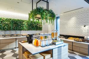 a restaurant with a counter with food on it at Tokyu Stay Shinjuku Eastside in Tokyo