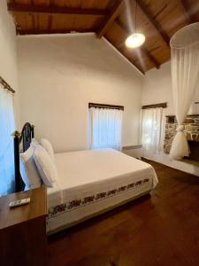a bedroom with a large white bed with white pillows at Zeytin in Datca +28 photos