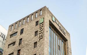 a brick building with a sign on the side of it at Jardin Hotel in Seoul