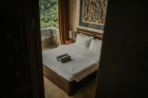 a bedroom with a bed with a suitcase on it at Uluwatu Mansion Villas in Uluwatu +149 photos
