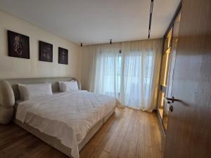 a bedroom with a bed and a large window at Luxury 1 bedroom at La marina in Casablanca