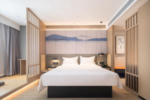 Postel nebo postele na pokoji v ubytování Jin Yi Youxuan Hotel Jungar Banner Government Branch