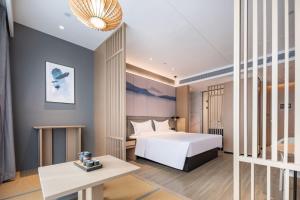 Postel nebo postele na pokoji v ubytování Jin Yi Youxuan Hotel Jungar Banner Government Branch + 6 fotografií