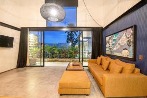 a living room with a couch and a large window at New Duplex apartment 200m to Beach Canggu in Canggu