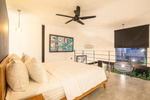 a bedroom with a bed and a ceiling fan at New Duplex apartment 200m to Beach Canggu in Canggu