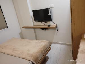 a room with a desk with a computer on a shelf at Hotel Sai Pratham in Shirdi +15 photos