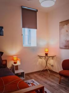 a living room with a couch and a table at Location Appartement Les Ondes in Albertville