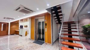a hallway with a staircase in a house at The Paradise Platinum in Kanchipuram