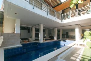 a house with a swimming pool and a balcony at RedDoorz at Anton's Loft Designer Resort Pansol Calamba Laguna in Laguna