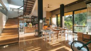 a dining room with tables and chairs in a house at RedDoorz at Anton's Loft Designer Resort Pansol Calamba Laguna in Laguna