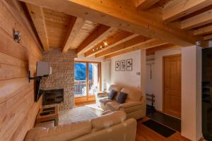 a living room with a couch and a fireplace at Wonderful appartment Monte Civetta in Dolomites in Alleghe