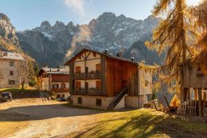 a building with mountains in the background at Wonderful appartment Monte Civetta in Dolomites in Alleghe