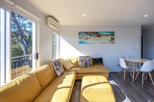 a living room with a couch and a table at Onetangi Ocean View - Waiheke Island in Waiheke Island