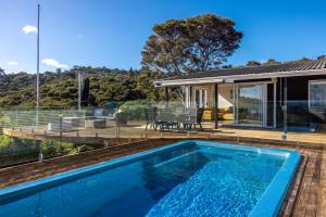 a swimming pool in the backyard of a house at Onetangi Ocean View - Waiheke Island in Waiheke Island