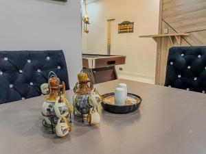 a table with two bottles and a candle on it at Blooms Manor Apartments in Lagos +9 photos