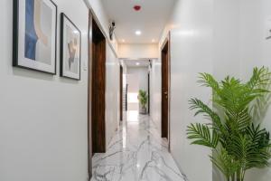 a hallway with marble flooring and framed pictures at FabHotel New 7 Star in Mumbai