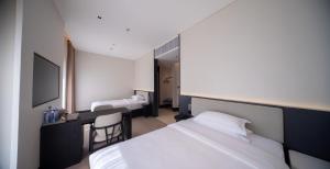 Ένα ή περισσότερα κρεβάτια σε δωμάτιο στο Yunyi Zizai Hotel Hohhot Agricultural University Branch +6 φωτογραφίες