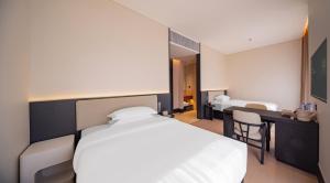 Ένα ή περισσότερα κρεβάτια σε δωμάτιο στο Yunyi Zizai Hotel Hohhot Agricultural University Branch