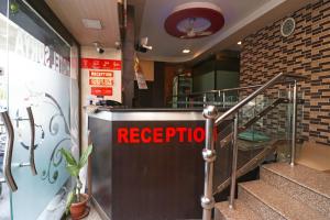 a restaurant with areciprocal sign on the side of the stairs at Super Hotel O by OYO Surya Continental in Lucknow