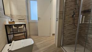 a bathroom with a shower and a toilet and a sink at Talenti Suites Rome Casa Vacanze in Rome +52 photos