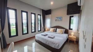 a bedroom with a bed and some windows at Samati Hill - Sunset Pool Villa 6 - Klong Ning Beach in Ko Lanta Yai +47 photos