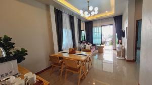 a living room with a dining room table and a couch at Samati Hill - Sunset Pool Villa 6 - Klong Ning Beach in Ko Lanta Yai