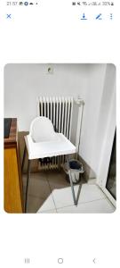 a white table in a room with a radiator at Dreaming of Greece A4 in Athens