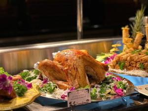 a large turkey on a plate on a table with other foods at Crowne Plaza Danang, an IHG Hotel in Danang