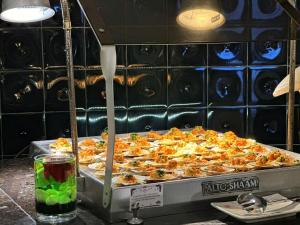 a large pizza sitting on top of a table at Crowne Plaza Danang, an IHG Hotel in Danang