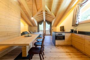 a kitchen with a long wooden table and chairs at Mot chalet in Valdidentro