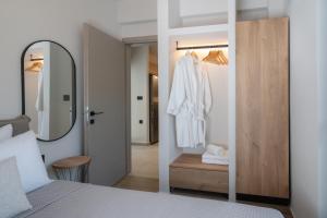 a bedroom with a bed with a mirror and a closet at Paizan Homes - Kos City Center Apartments in Kos +80 photos