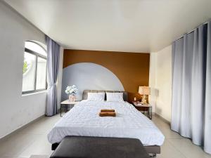 a bedroom with a large bed and a window at LV TPHomes in Ho Chi Minh City +82 photos