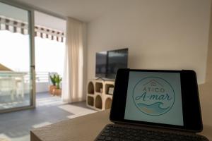 a laptop computer sitting on a table in a room at Ático A-mar in Puerto Naos