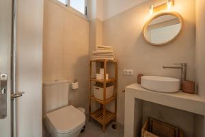 a bathroom with a sink and a toilet and a mirror at Ático A-mar in Puerto Naos +15 photos