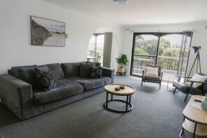 a living room with a couch and a table at Beacon Point House in Port Campbell +26 photos