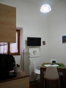 a small kitchen with a table and a refrigerator at Casa Martina in Castellammare di Stabia