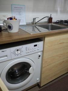 a kitchen with a washing machine and a sink at Casa Martina in Castellammare di Stabia