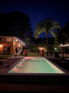 a swimming pool in front of a house at night at Quinta da Bocaina in Amparo