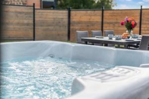 een badkuip gevuld met water met tafels en stoelen bij 2 Bed in Pancrasweek oc-o30445 in Pancrasweek