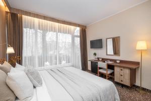 Postel nebo postele na pokoji v ubytování Nėris Inn Terraces