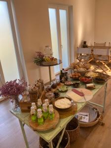 a table with a bunch of food on it at So Magoito Tiny house in Sintra