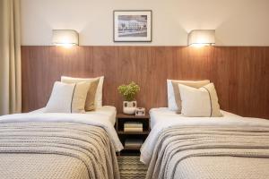 a hotel room with two beds in a room at Nėris Inn Terraces in Vilnius